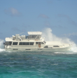 Motor cruiser sinks after running aground on reef