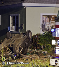 Car flips and smashes into Bodden Town house